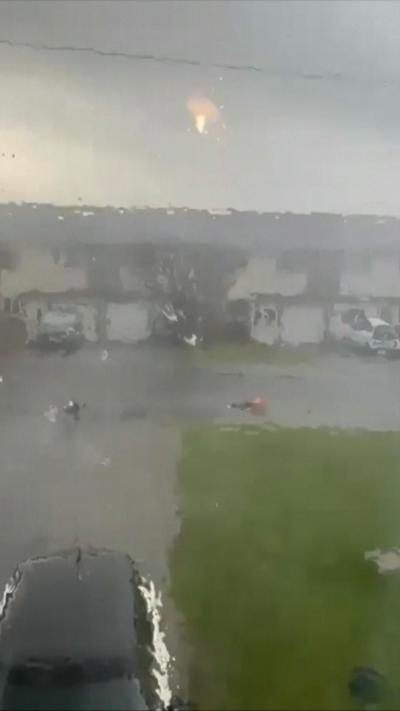 View from window onto residential street below during mini tornado