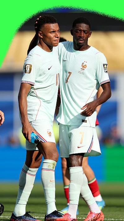 Ousmane Dembélé gives Kylian Mbappe a pat on the back after doubling France's lead against Morocco