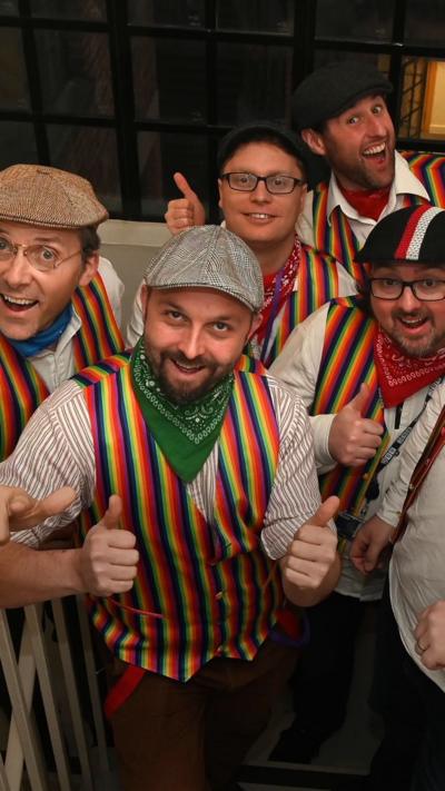 Group of men in strippey waistcoats wearing flat caps