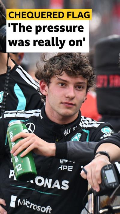Kimi Antonelli in Mercedes race suit holds green water bottle 