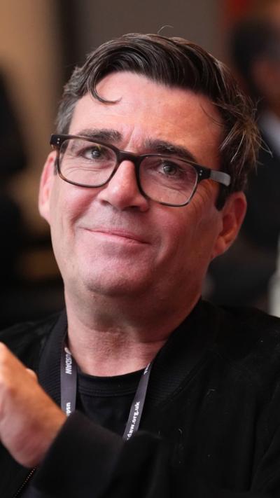 A picture of Andy Burnham wearing glasses and looking off to his left 