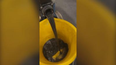 Black liquid pours from with fluid collected from Tube seats into bucket