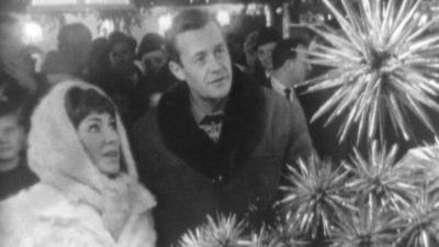 Christopher Trace and Valerie Singleton admire stars at a Christmas Market stall