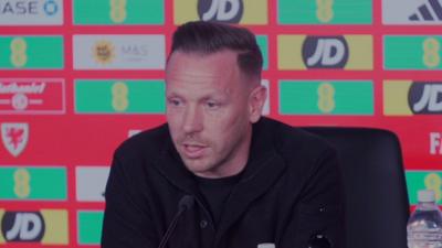 Craig Bellamy speaking at a media conference