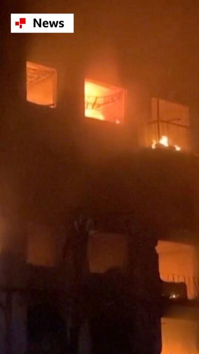 A building in Ukraine is engulfed in flames after being hit by ballistic Russian missiles