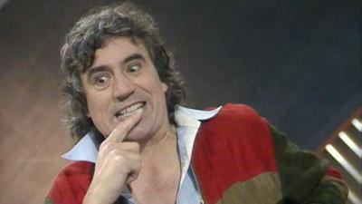 Terry Jones sitting in the Wogan studio.