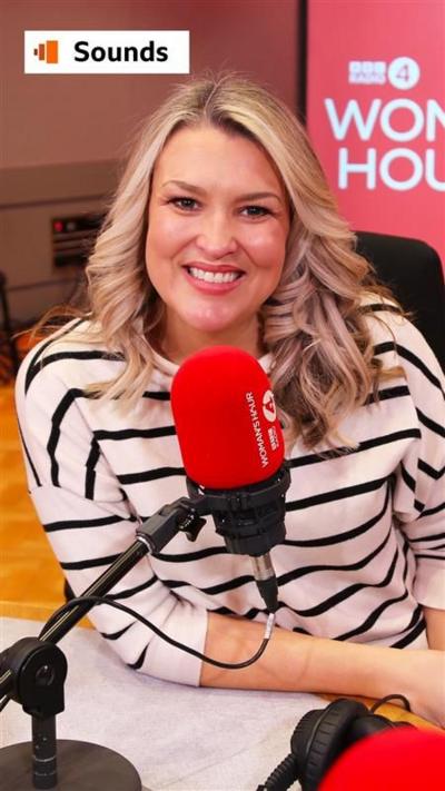 Sara Davies in front of a mic in the Woman's Hour studio, wearing a black and white striped top and with blonde hair.