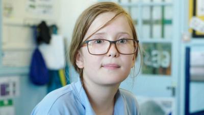 Young school girl wearing glasses