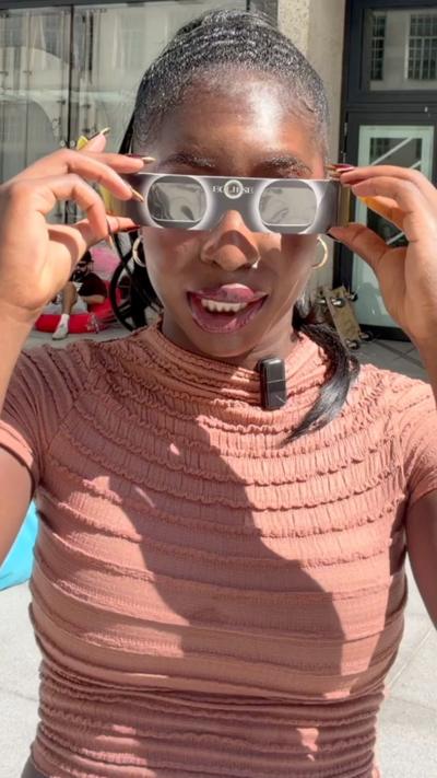 Jonelle Awomoyi using eclipse glasses