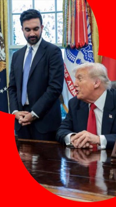 Zohran Mamdani gestures as he speaks standing next to a seated Donald Trump in the Oval Office.