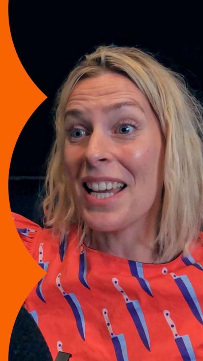 Sara Pascoe smiles in a backstage area 