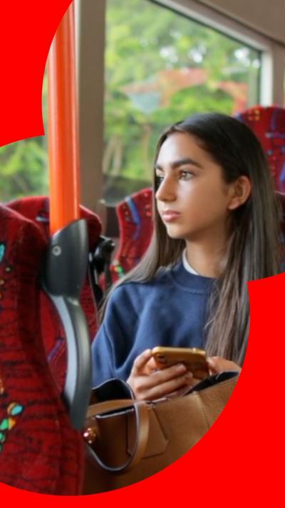 Young girl sits on bus