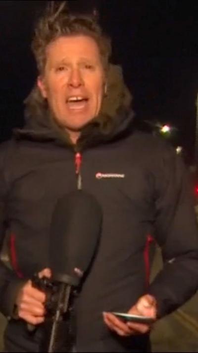 Man with his hair being blown all over the place