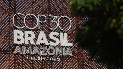The COP30 sign with Brasil and Amazonia writing is seen through trees