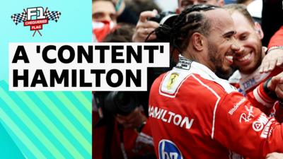 Lewis Hamilton smiling in Ferrari race suit 