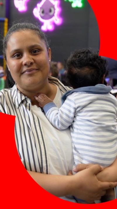 A woman holds a baby