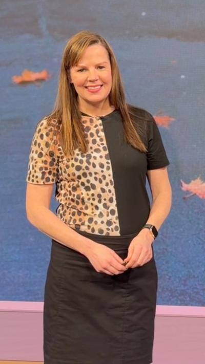 Alexis Green stands in the studio smiling.