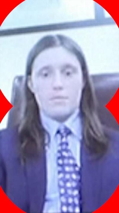 Man with long hair in suit