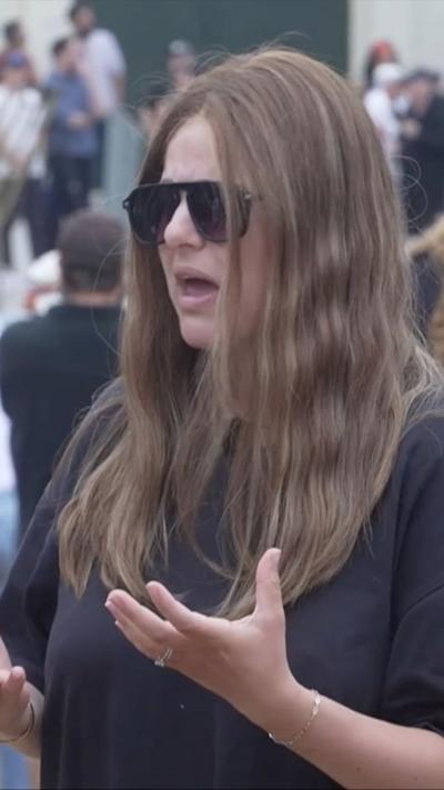 Chavi, a survivor of the Bondi attack. She is wearing a black t-shirt and black sunglasses.