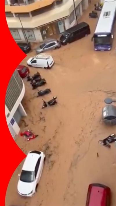 Cars and a bus in flood water, seen from above