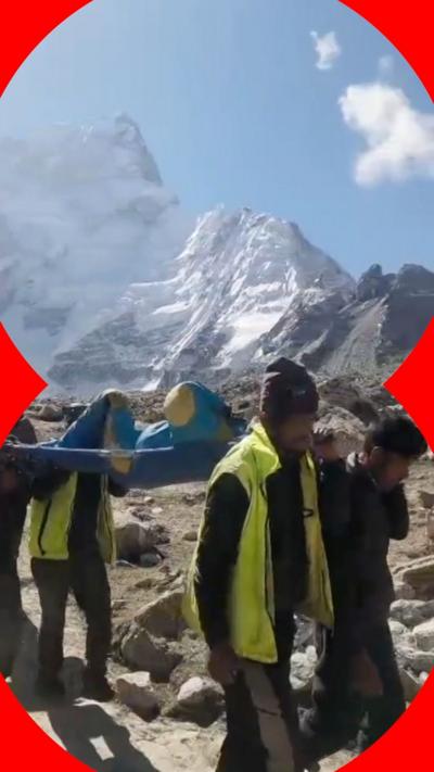 Survivor carried by rescuers