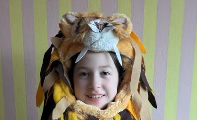 Child wearing a lion's mane headdress as part of a Luna Lovegood costume