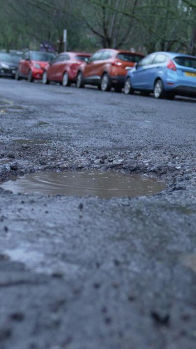 A road strewn with potholes