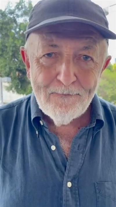 Jeremy Bowen wearing a cap and a blue shirt 