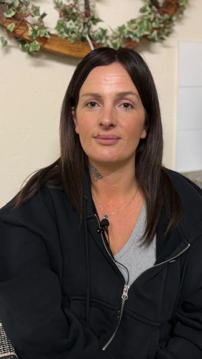 A women with brown hair looking directly at the camera