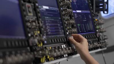 We see an astronaut training in a mission simulator.