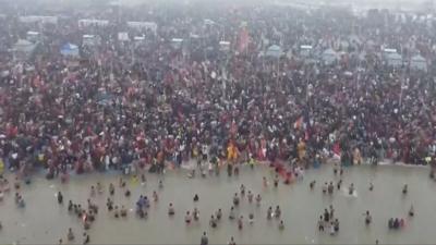 Large crowd of people on river bank