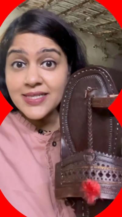 A woman holds a Sandal