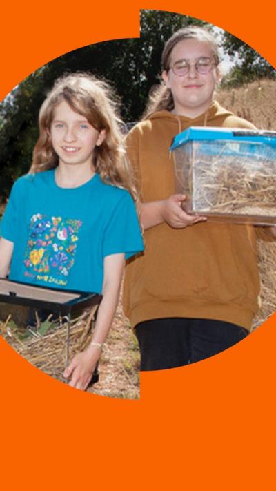 Two teenagers, Emily and Eva, holding boxes and smiling