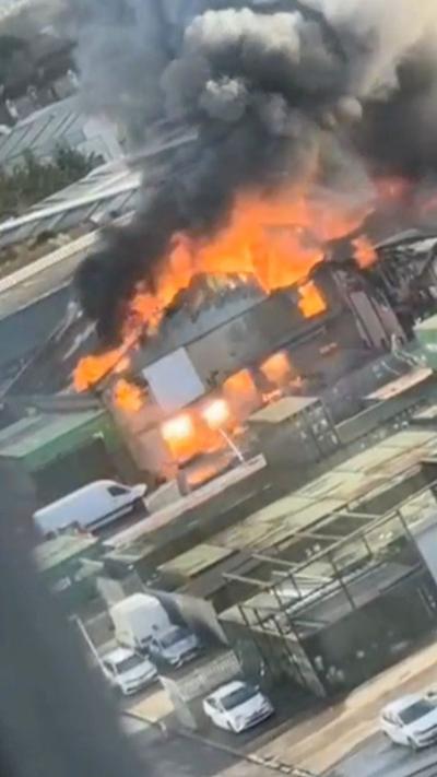 Flames and smoke emerged from a building in the middle of the picture