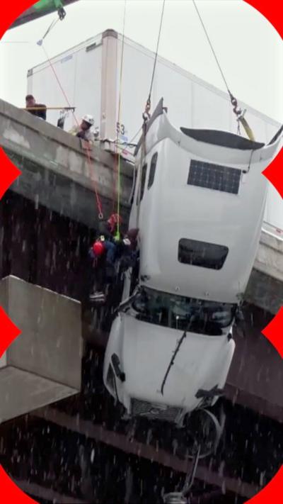 Driver hoisted to safety from truck dangling over US bridge