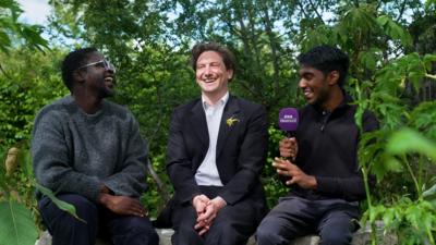Newsround's De-Graft with garden designer Charlie Chase and young garden volunteer Yash
