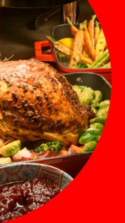 Full cooked turkey on a bed of sprouts with parsnips in the background.