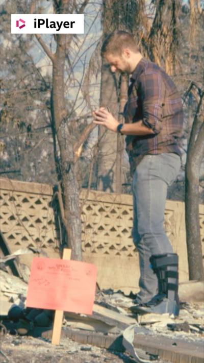 A man stood on top of rubble