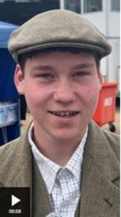 A young farmer wearing a cap speaks to the camera at the Great Yorkshire Show