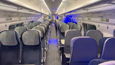 Rows of empty seats on a train carriage.