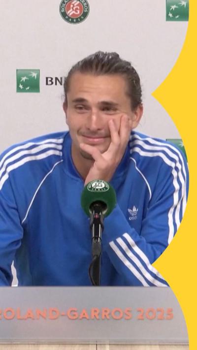 Alexander Zverev sits behind a desk during a press conference in France