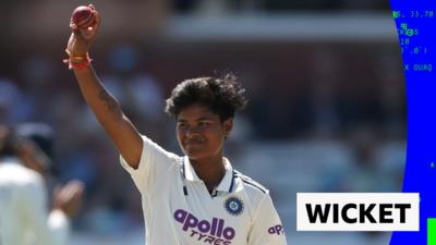 Kranti Gaud holding the ball up for her five wicket hall