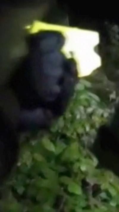 A blurry image of an armed policeman