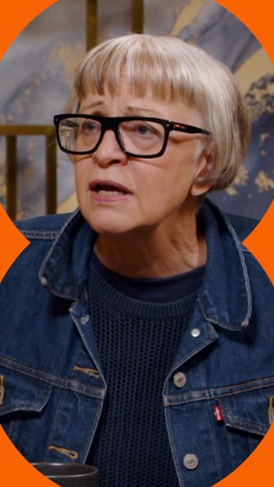 Philippa Perry has light short hair and is wearing black glasses.