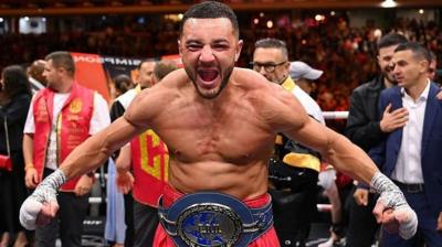 Callum Simpson celebrates with belt around his waist