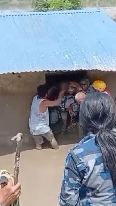 Person covered in mud rescued from house