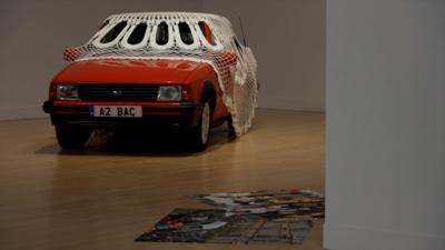 Jasleen Kaur's piece features a vintage orange Ford Escort covered by a white doily. 