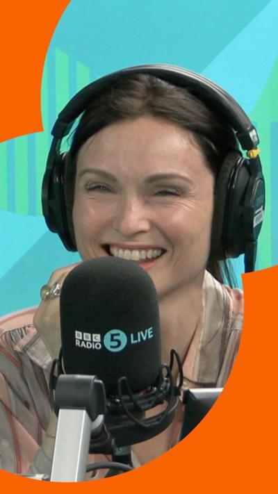 Sophie Ellis-Bextor smiling in the Radio 5 Live studio, wearing headphones, behind a mic.