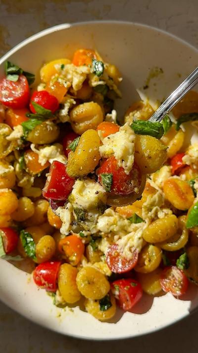 Crispy gnocchi Caprese salad in a white bowl.