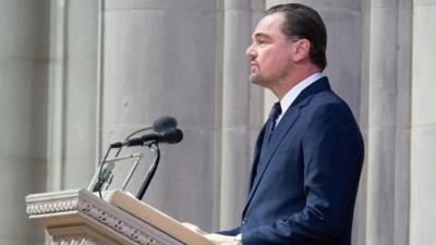 A man in a suit standing at a church lectern.